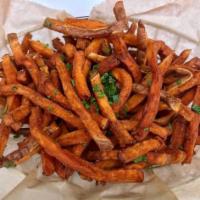 Basket of Sweet Potato Fries · A basket of crispy, hand-cut sweet potato fries.