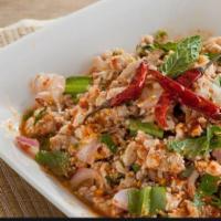Chicken Salad (Larb Gai) · Minced chicken, red onion, green onion, lime juice, roasted rice powder & bed of mixed veggie.