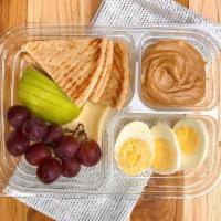 Protein Snack Tray · Wheat pita, red grapes, hard boiled eggs, creamy peanut butter and havarti cheese.