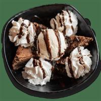 Hot Fudge Brownie · Walnut-covered chocolate brownie served with vanilla ice cream, fudge and whipped cream on t...