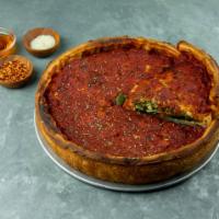 Spinach Pesto Deep Dish Pizza · Fresh spinach, pesto, homemade tomato sauce. Topped with a thin layer of extra dough and hom...