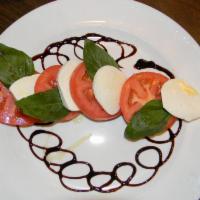 Mozzarella Caprese · Fresh mozzerella, tomato and basil.