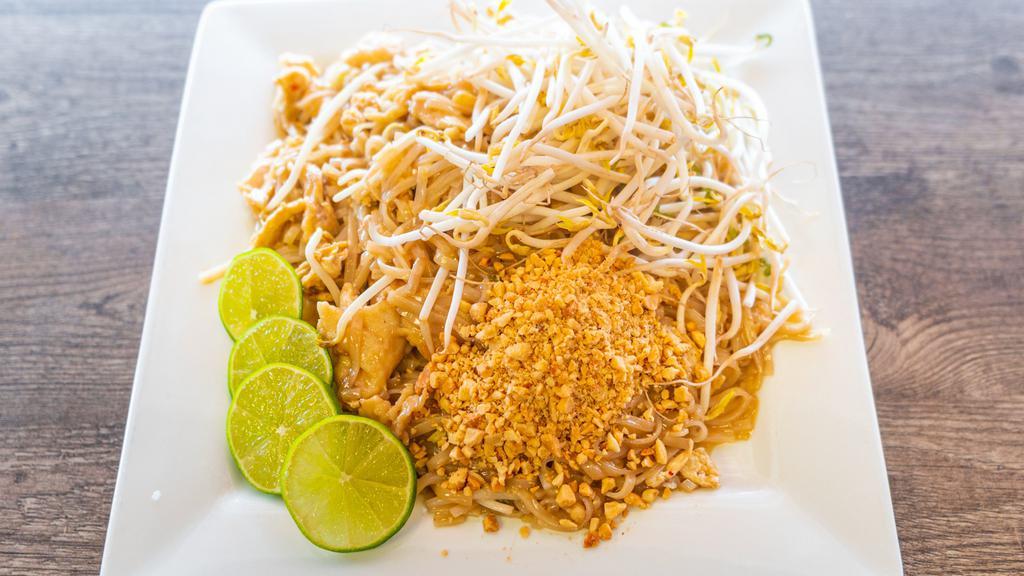 N1. Pad Thai · Stir-fried rice noodles, egg, green onions, and bean sprouts. Topped with crushed peanuts, a slice of lime and bean sprouts on the side.