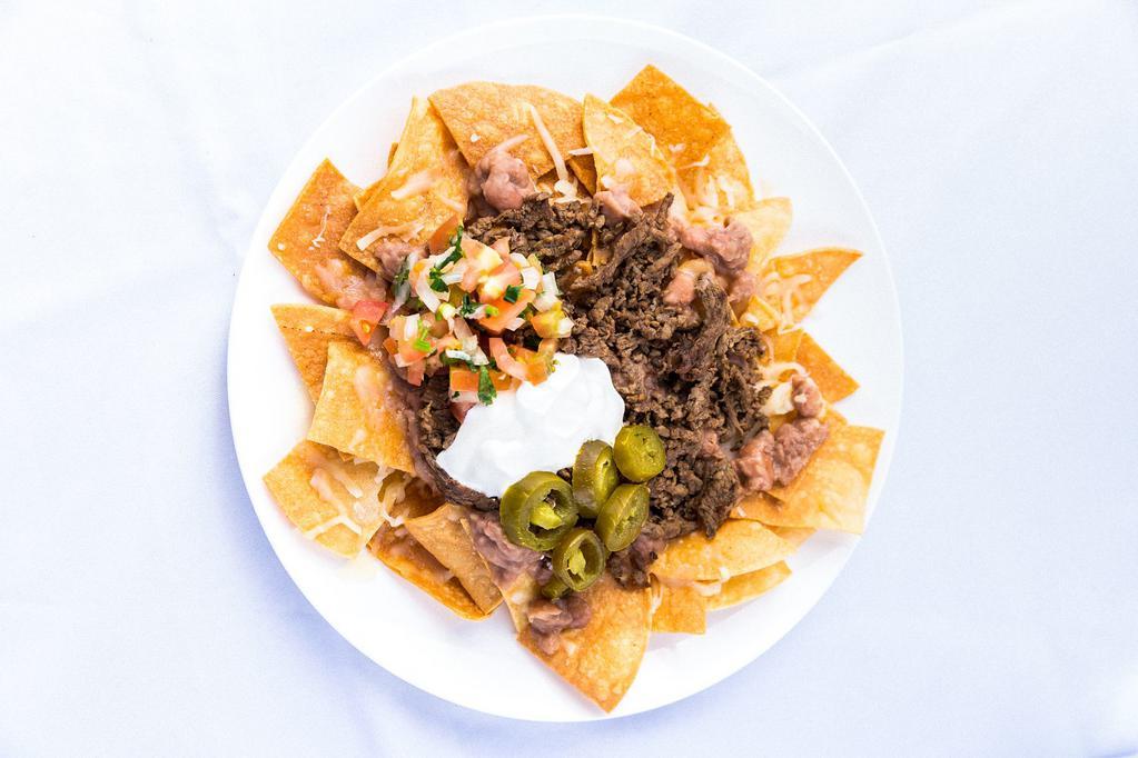La Villa Nachos · Chips, choice of Monterrey Jack cheese or yellow nacho cheese, beans, pico de gallo, sour cream, and jalapenos.