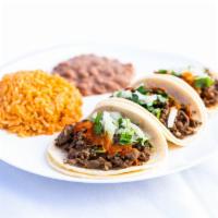 Three Taco Combo · Hot Sauce, onions, and cilantro. Combo includes three tacos, rice, beans, and a medium drink.