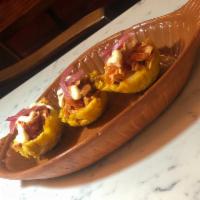 Mofonguitos · crispy plantain cups, mojo chicken, pickled onions 