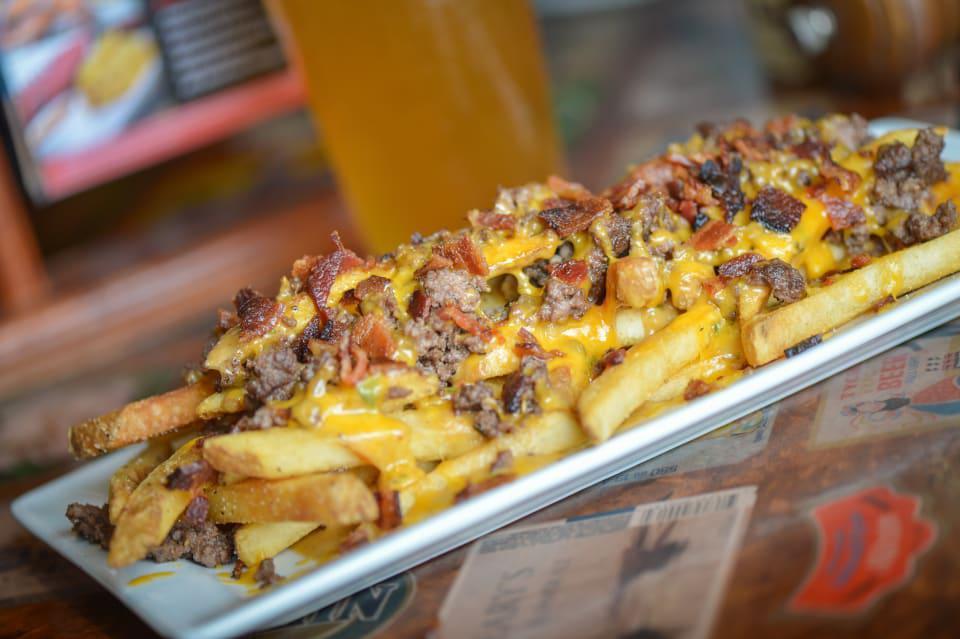 Cheeseburger Fries · Seasoned ground chuck, roasted pepper cheese sauce, sugar cured bacon and cheddar cheese.