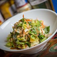 Asian Chicken Salad · Cilantro, carrots, tortilla strips, peanut sauce, green onions and honey lime vinaigrette.