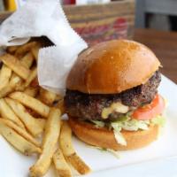 Juicy Lucy Burger · Cheddar-jack stuffed patty, lettuce, tomatoes and pickles.