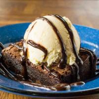 Double Fudge Chocolate Brownie · Chocolate brownie topped with a scoop of vanilla ice cream and chocolate sauce.