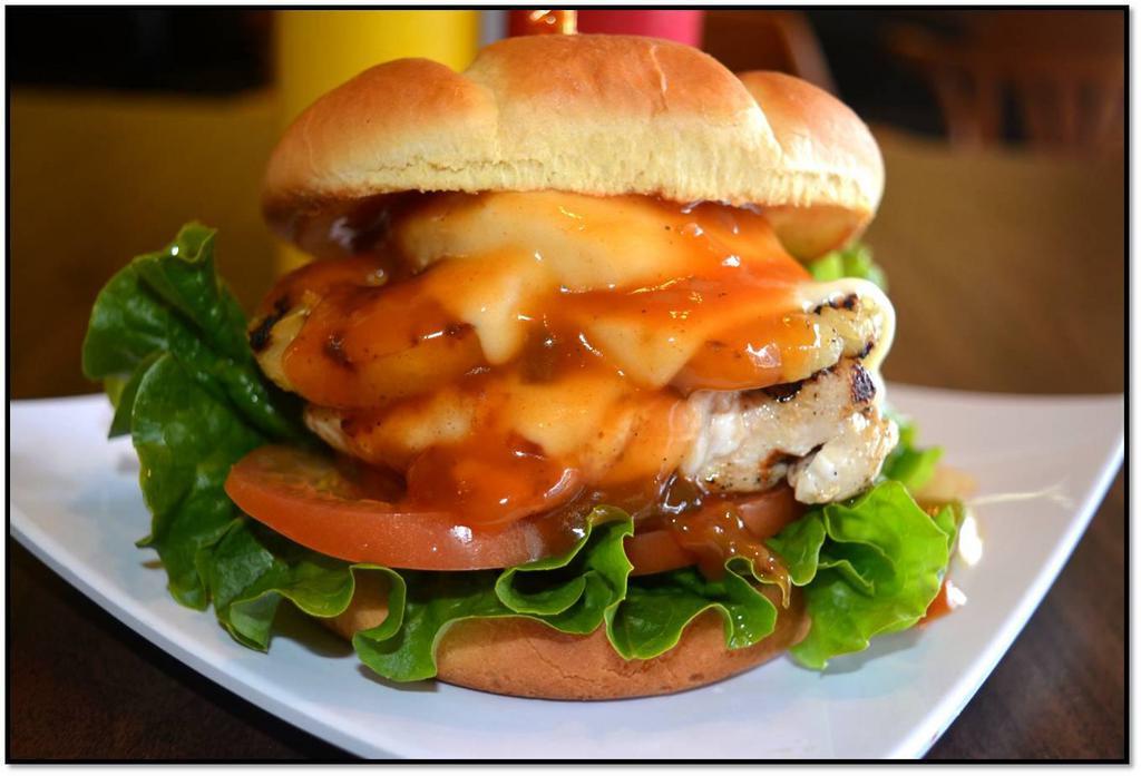 Hawaiian Chicken Sandwich · Grilled pineapple on top of grilled chicken breast. Served with Hawaiian sweet and sour sauce. Add cheese for an additional charge. Add bacon for an additional charge.