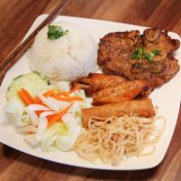 44. Grilled Pork Chop, Fried Chicken Wings and Egg Rolls Over Rice Plate · 