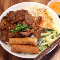 40. Grilled Pork and Egg Rolls Over Vermicelli · 