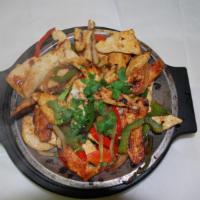 Fajitas de Pollo · Chicken slices mixed with bell pepper, onion, tomato and cilantro. Served with rice, beans a...