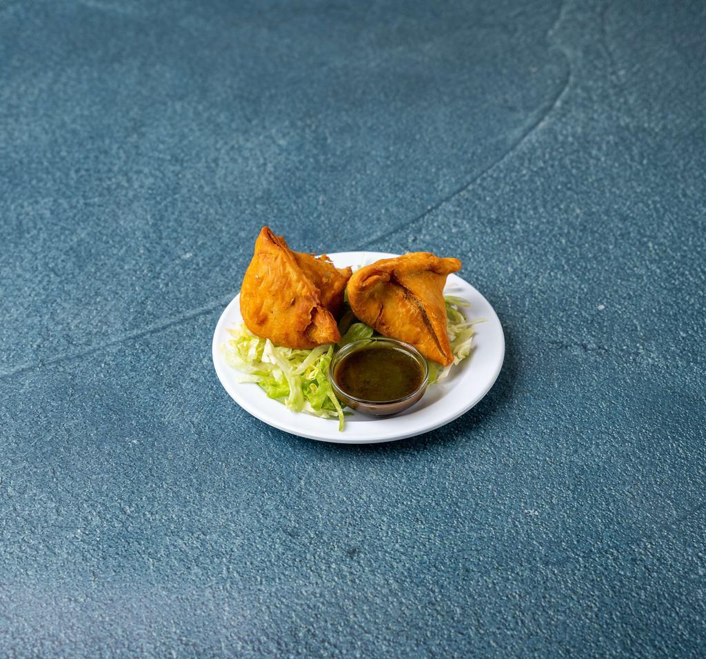 Samosa  · 2 crispy pastries filled with your choice of freshly mixed vegetables or delicately spiced lean ground beef.