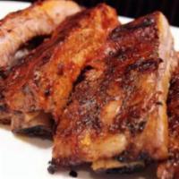 Pork Ribs with BBQ Sauce · Served with rice and sweet plantains
