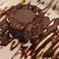 Decadent Chocolate Cake · Drizzled with chocolate and served with a strawberry garnish