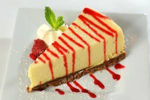 Strawberry Cheesecake · Light and creamy no-bake vanilla cheesecake with ginger cookie crust, topped with fresh strawberry confit.