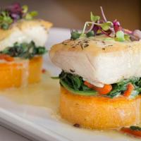 Pacific Halibut · Fresh-cut and pan-seared halibut over roasted read pepper polenta cakes with sautéed spinach...