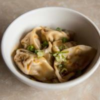 Pork and Vegetable Dumpling · Filled with ground pork and vegetables, served with soy sauce, sesame oil, and chili oil.