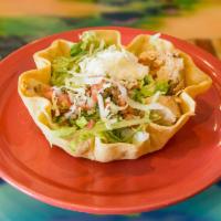 122. Fajita Taco Salad · A crispy flour tortilla with fried beans, grilled chicken or beef, onions, tomatoes and bell...