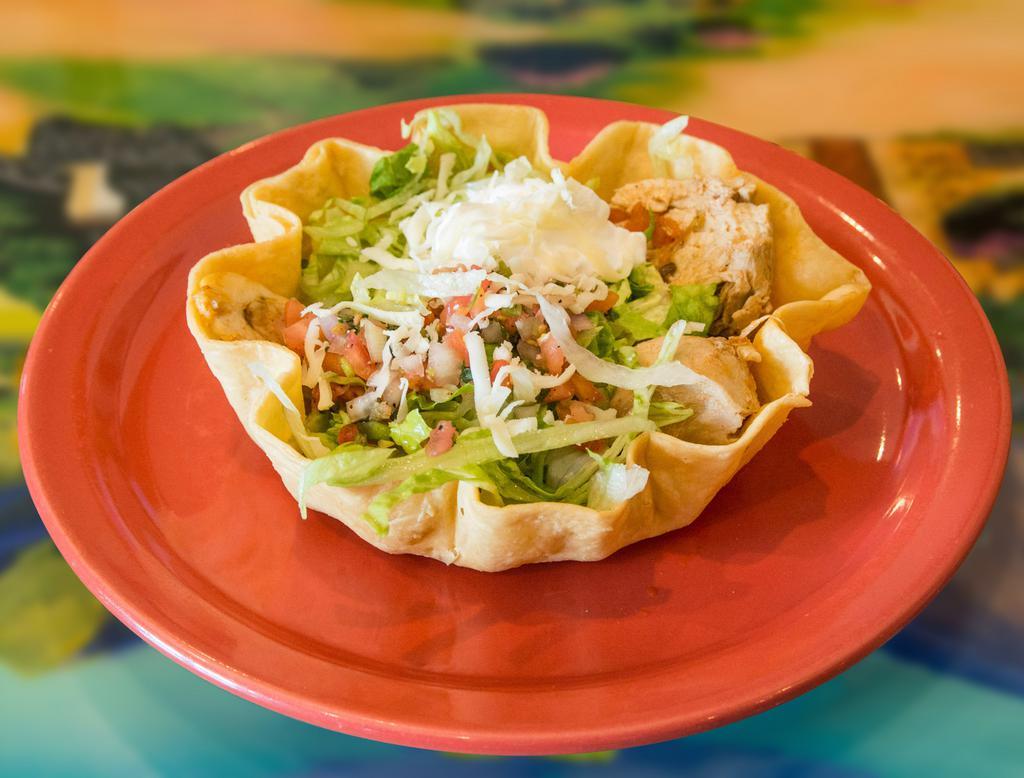 122. Fajita Taco Salad · A crispy flour tortilla with fried beans, grilled chicken or beef, onions, tomatoes and bell peppers. Topped with lettuce, tomatoes, sour cream and cheese.