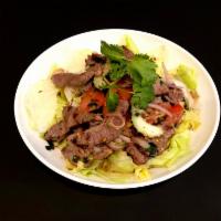 22. Beef Salad (GF) · Grilled sliced beef, tomato, onions, cilantro, cucumber, lettuce, and mint mixed with spicy ...