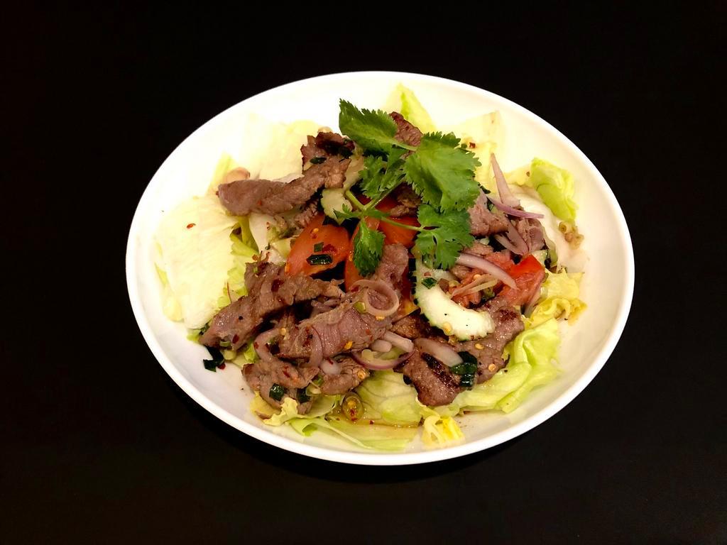 22. Beef Salad (GF) · Grilled sliced beef, tomato, onions, cilantro, cucumber, lettuce, and mint mixed with spicy lime dressing over lettuce.