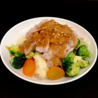 57. Pra Ram (GF)(VG) · Steamed broccoli, carrot, cabbage and corn on top with peanut sauce.