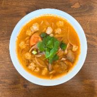 67. Tom Yum Noodle Soup · Steamed rice noodle in Tom Yum soup with ground chicken, mushroom, onion and cilantro