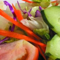 Toss Salad · Fresh lettuce, tomatoes, cucumbers, shredded carrots and red pepper with homemade Hawaiian s...