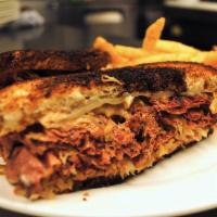 Reuben Sandwich · House cooked corned beef, Thousand Island dressing, sauerkraut, and melted Swiss cheese on m...