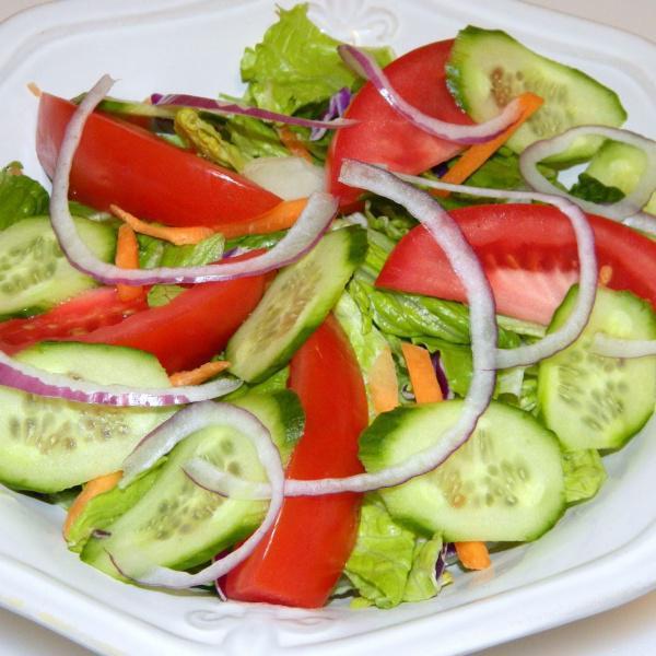 Mixed Green Salad · Slices of carrot, cucumber, lettuce, onion, tomato, and lemon.