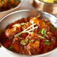 Kadai Chicken · Pan seared chicken, traditional desi style with onion, pepper, and tomatoes. Served with rice.