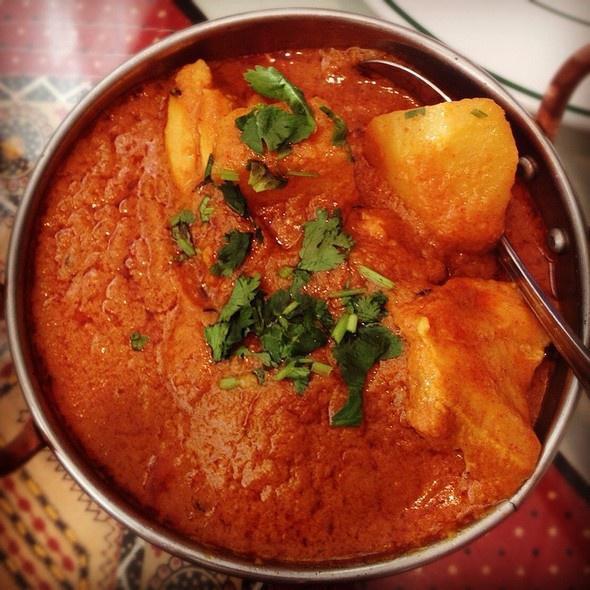 Chicken Vindaloo · Goan special chicken simmered in fiery hot sauce with potato. Served with rice.