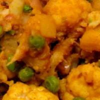 Aloo Gobhi Mutter · Potatoes and cauliflower cooked in fresh ginger, garlic, tomatoes, and herbs. Served with ri...