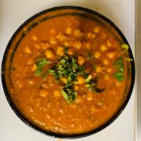 Chana Masala · Garbanzo beans cooked in traditional Indian style onion and tomato sauce. Served with rice.