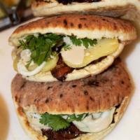Sabich Pita Sandwich · Homemade hummus, fried eggplant, hard boiled egg, potato, Israeli salad, and fresh parsley, ...