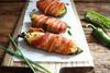 Sliced Poppers · Jalapeños poppers. Freshly sliced jalapeños filled with cream cheese and wrapped with bacon.