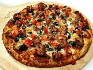Creamy Garlic Combination Pizza · Rich and creamy garlic sauce and mozzarella cheese with pepperoni, Italian sausage, mushrooms, black olives, green onions and cooked tomatoes.