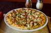 Buffalo Bacon Ranch Slice Pizza · Tangy ranch sauce with buffalo wings, breakfast bacon, green onions and cooked tomatoes.