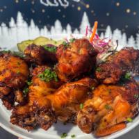 1 lb. Smoked Chicken Wings · 12-hour pickle brined, dry-rubbed, smoked and fried with slaw and lime. Add signature sauce ...