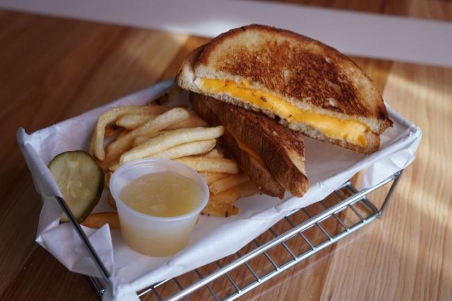Kids Grilled Cheese · A grilled cheese sandwich with american cheese. Served with your choice of fries and applesauce.