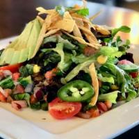 Southwest Salad · Mixed greens, corn and black bean relish, tortilla strips, avocado and tomato. Topped with p...