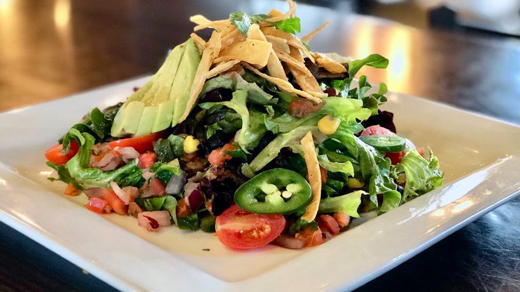 Southwest Salad · Mixed greens, corn and black bean relish, tortilla strips, avocado and tomato. Topped with pico de gallo.