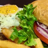 Sunshine Peak Burger · Smoked Gouda cheese, crispy bacon and a fried sunny-side egg on a brioche bun.