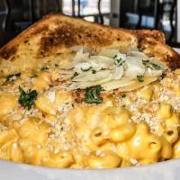 Mac 'N' Cheese · Our signature cheese sauce, topped with Parmesan.