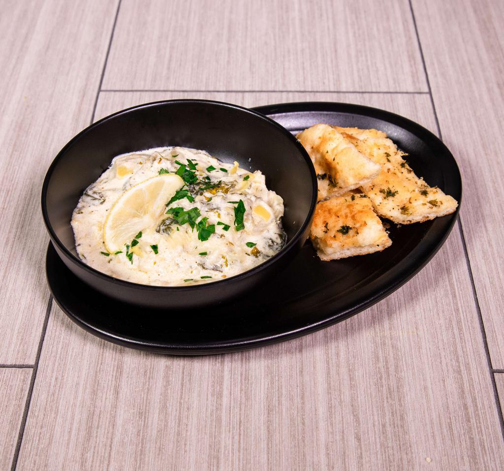 Spinach and Artichoke Dip · A blend of fresh spinach, kale, artichoke hearts and roasted garlic, swirled in creamy Alfredo sauce. Served with toasted focaccia bread.