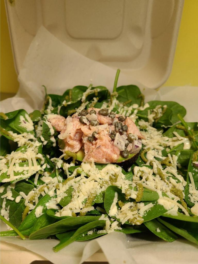 Smoked Salmon Tartare Salad  · Smoked salmon with capers, red onions, mixed with Caesar dressing. Served over a halved avocado and a bed of spinach. Topped with parmesan cheese, cracked pepper, Caesar, and arugula pesto.