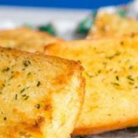 Garlic Bread · A 6 inch loaf of our home made Italian bread, halved, and toasted with garlic butter.